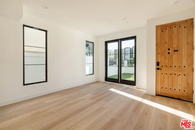an empty room with windows and closet