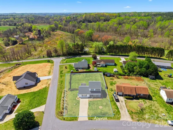 an aerial view of a house with yard swimming pool and outdoor seating