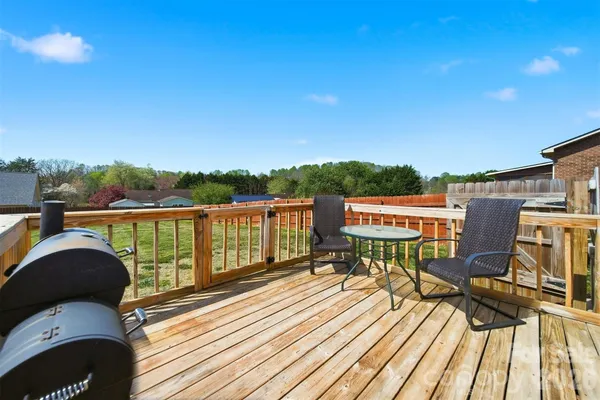 a view of balcony with wooden floor and seating space