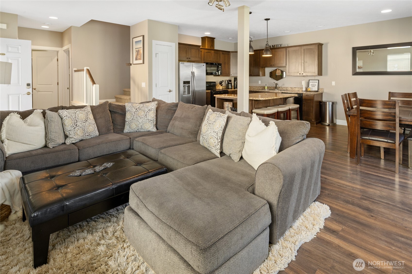 23041 Sunserra Loop Quincy, WA 98848 - Photo 11 of 38 a living room with furniture kitchen view and a wooden floor