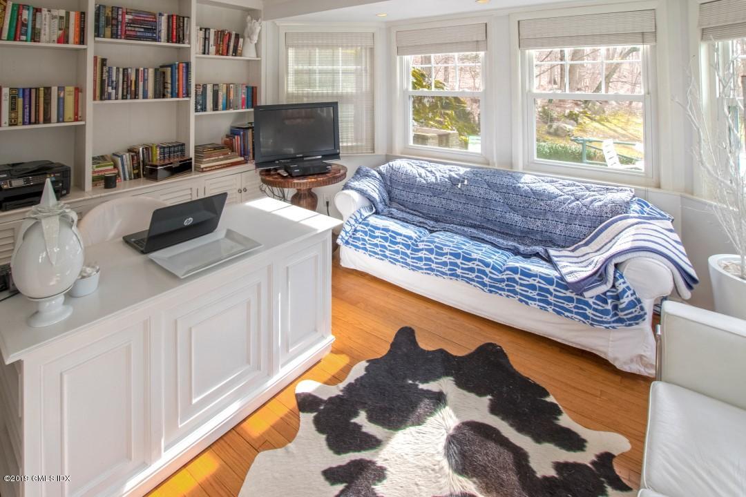 347 Riversville Road Greenwich, CT 06831 - Photo 11 of 22 a living room with a couch bookshelf and a fireplace