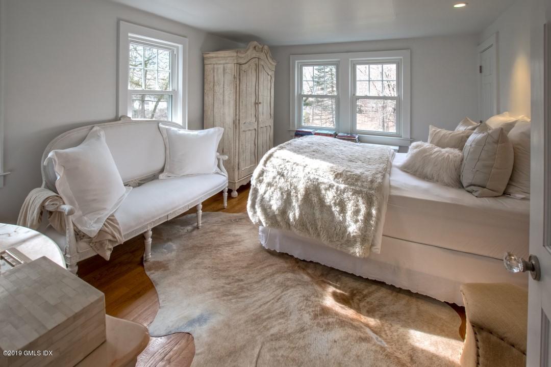347 Riversville Road Greenwich, CT 06831 - Photo 12 of 22 a bedroom with a bed couch and windows