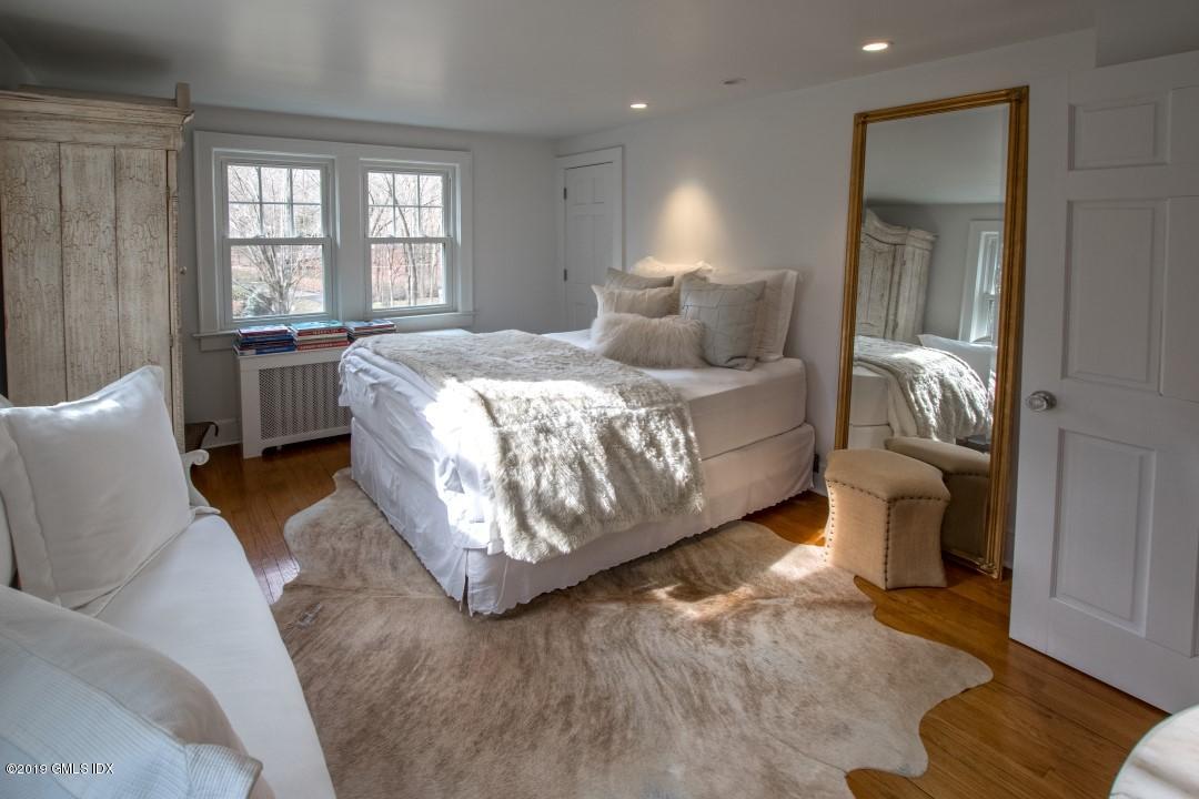 347 Riversville Road Greenwich, CT 06831 - Photo 13 of 22 a bedroom with a bed and a couch