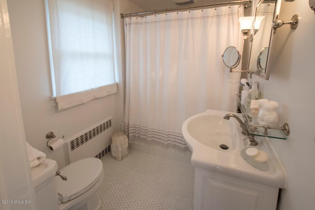 347 Riversville Road Greenwich, CT 06831 - Photo 14 of 22 a bathroom with a sink and a mirror