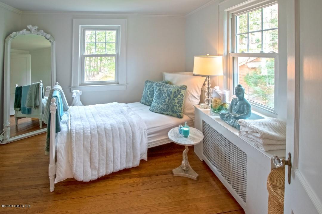 347 Riversville Road Greenwich, CT 06831 - Photo 15 of 22 a bedroom with a bed and a table