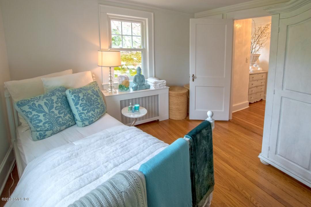 347 Riversville Road Greenwich, CT 06831 - Photo 16 of 22 a bedroom with a bed and wooden floor