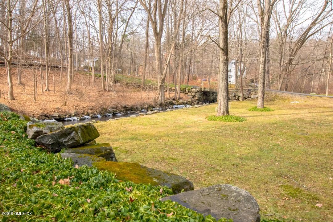 347 Riversville Road Greenwich, CT 06831 - Photo 20 of 22 a view of an ocean with large trees