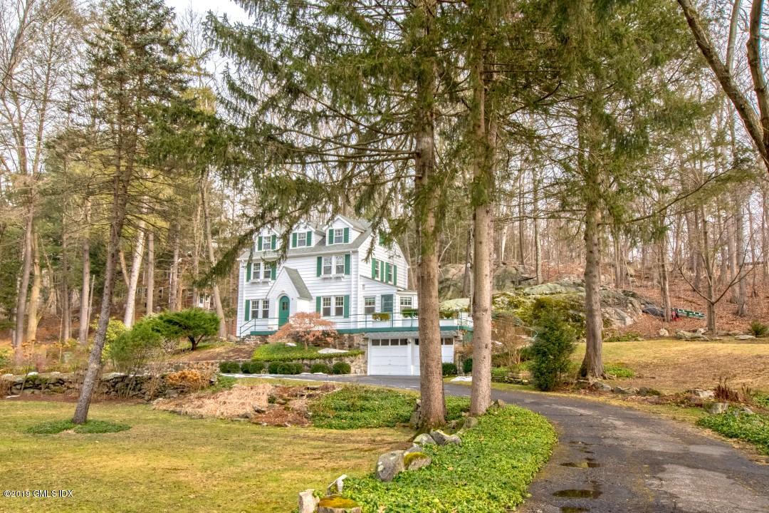 347 Riversville Road Greenwich, CT 06831 - Photo 21 of 22 a front view of a house with a yard and trees
