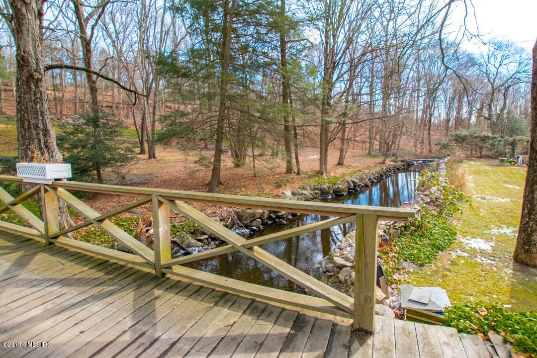 347 Riversville Road Greenwich, CT 06831 - Photo 3 of 22 a view of a balcony with wooden floor and fence
