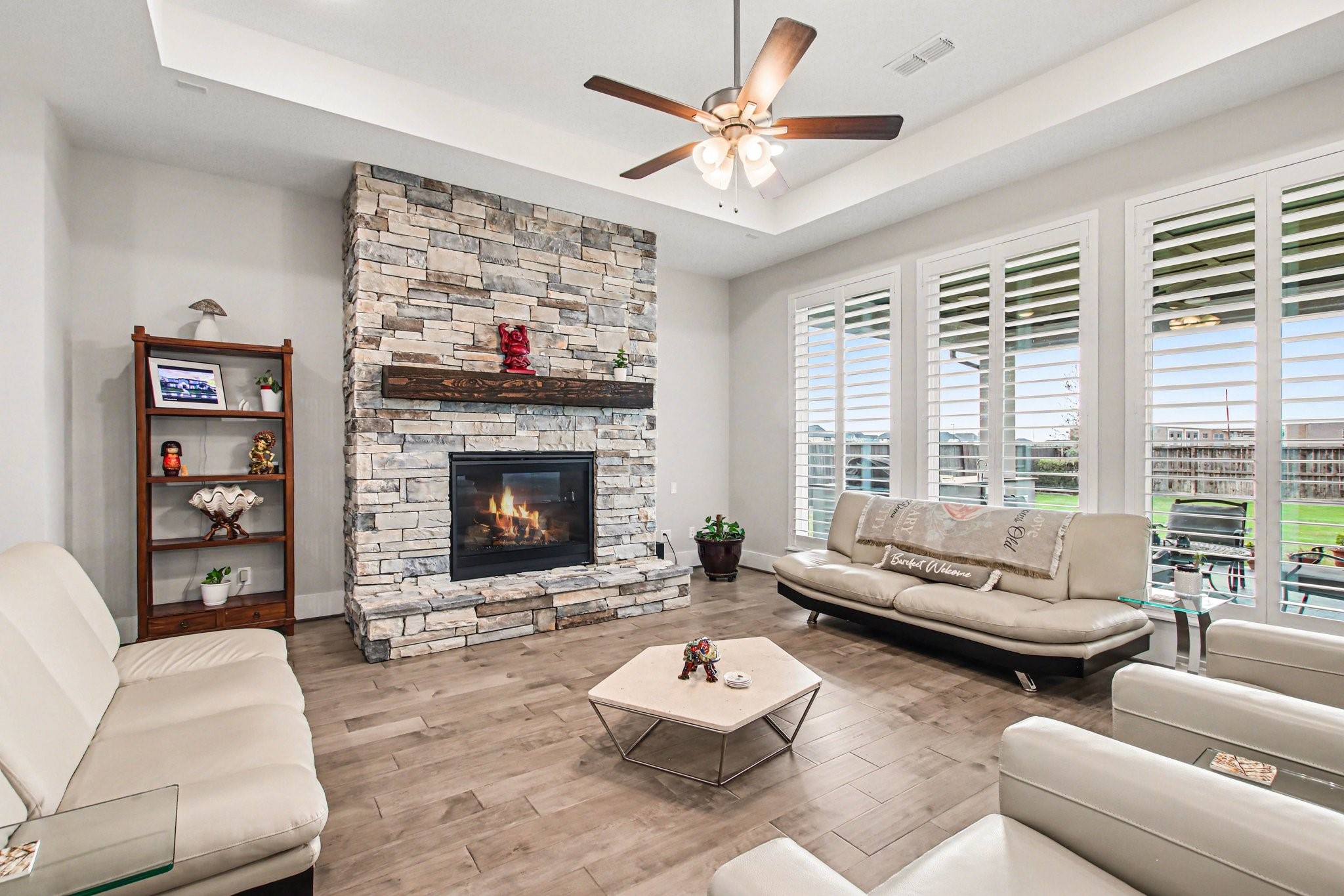 2311 Legends Way Katy, TX 77493 - Photo 11 of 50 Spacious family room featuring large windows, modern flooring, and an open layout ideal for both everyday living and entertaining.