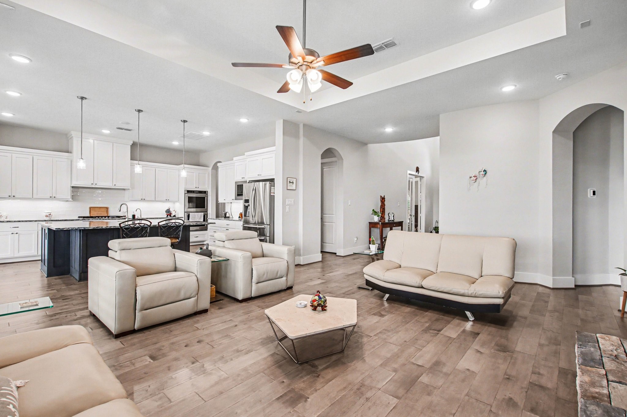 2311 Legends Way Katy, TX 77493 - Photo 13 of 50 Designed for both comfort and entertaining, this open living area offers generous seating space, elevated tray ceilings, and effortless connection to the kitchen and dining areas.