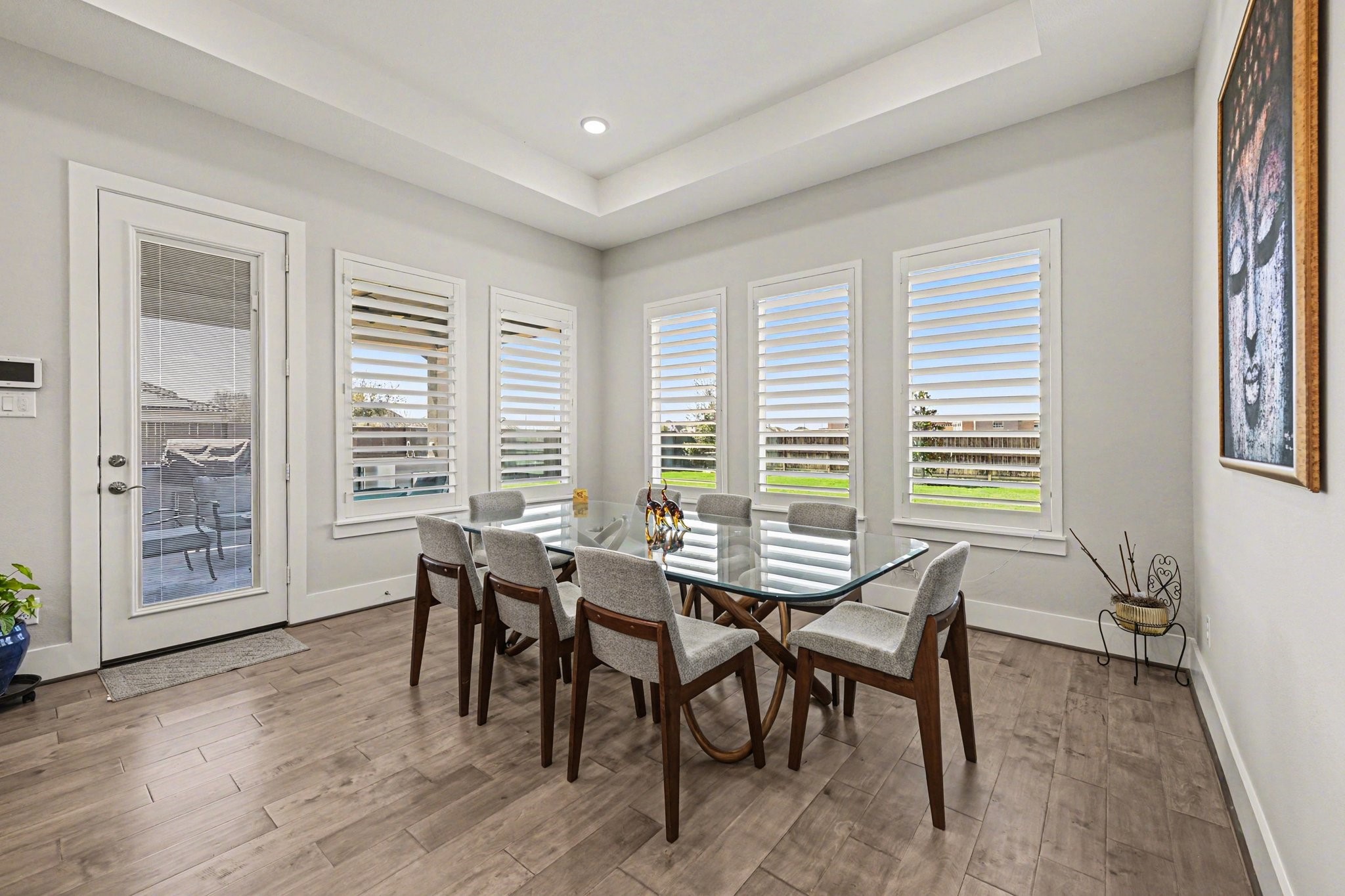 2311 Legends Way Katy, TX 77493 - Photo 15 of 50 Enjoy meals surrounded by walls of windows overlooking the backyard. The elegant dining space offers abundant natural light and easy access to the outdoor patio for seamless indoor-outdoor living.