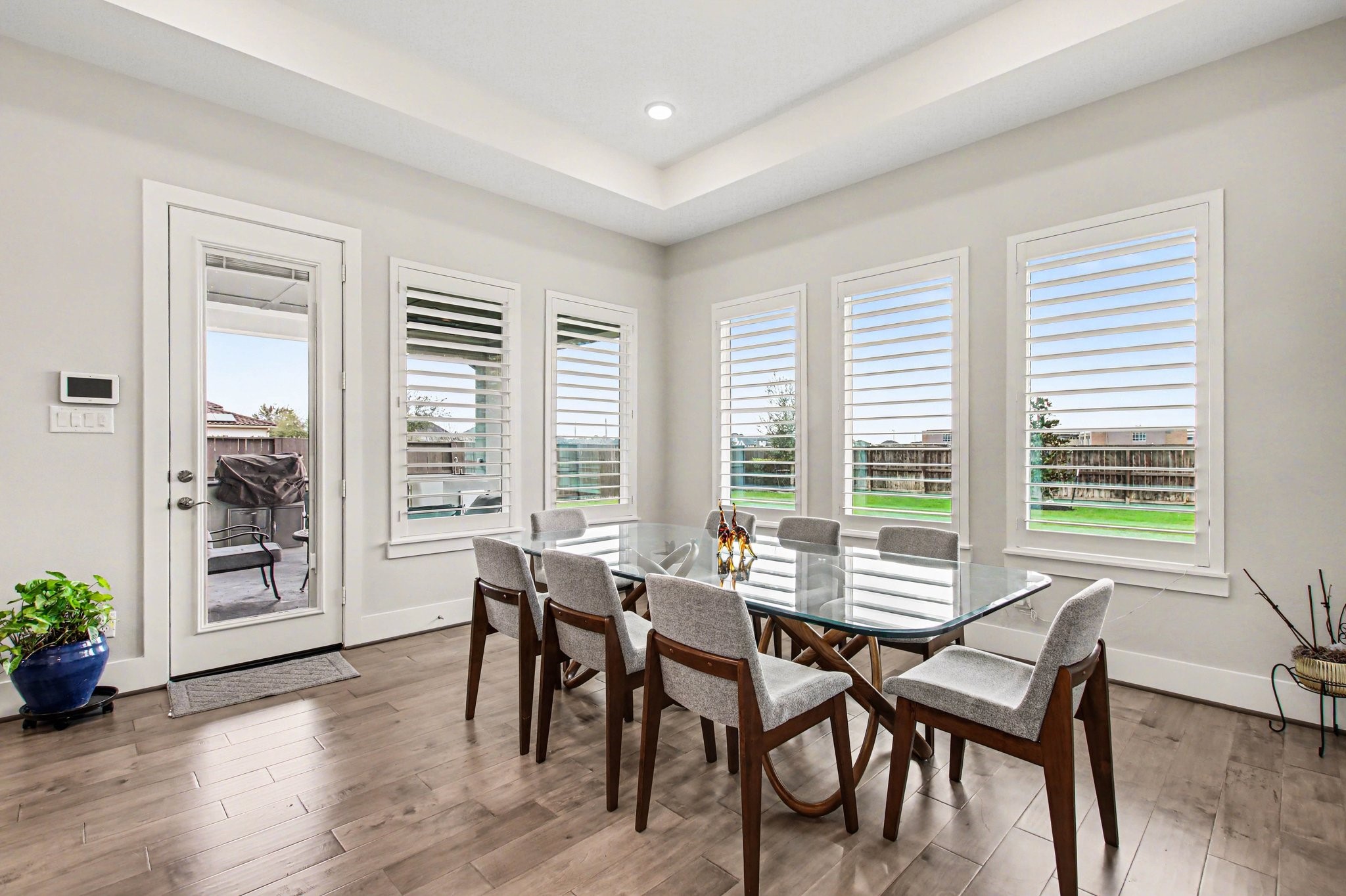 2311 Legends Way Katy, TX 77493 - Photo 16 of 50 Bright dining area surrounded by windows with plantation shutters, offering abundant natural light and views of the backyard.