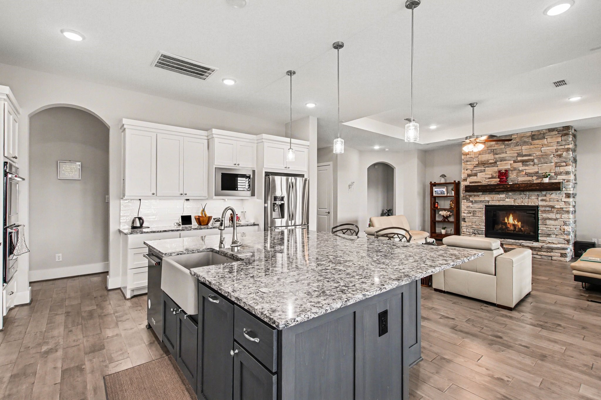 2311 Legends Way Katy, TX 77493 - Photo 19 of 50 High-end finishes continue with double ovens, subway tile backsplash, and extensive cabinetry for exceptional storage. Clean lines and timeless design create a bright, sophisticated culinary space.