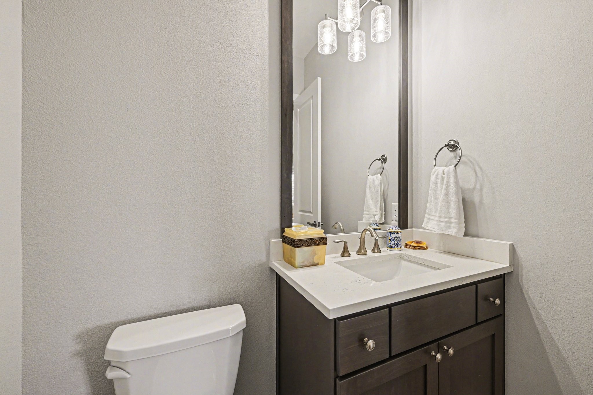 2311 Legends Way Katy, TX 77493 - Photo 21 of 50 Elegant guest powder bath featuring quartz countertops, modern fixtures, and a framed mirror with designer lighting—an elevated touch for visitors.
