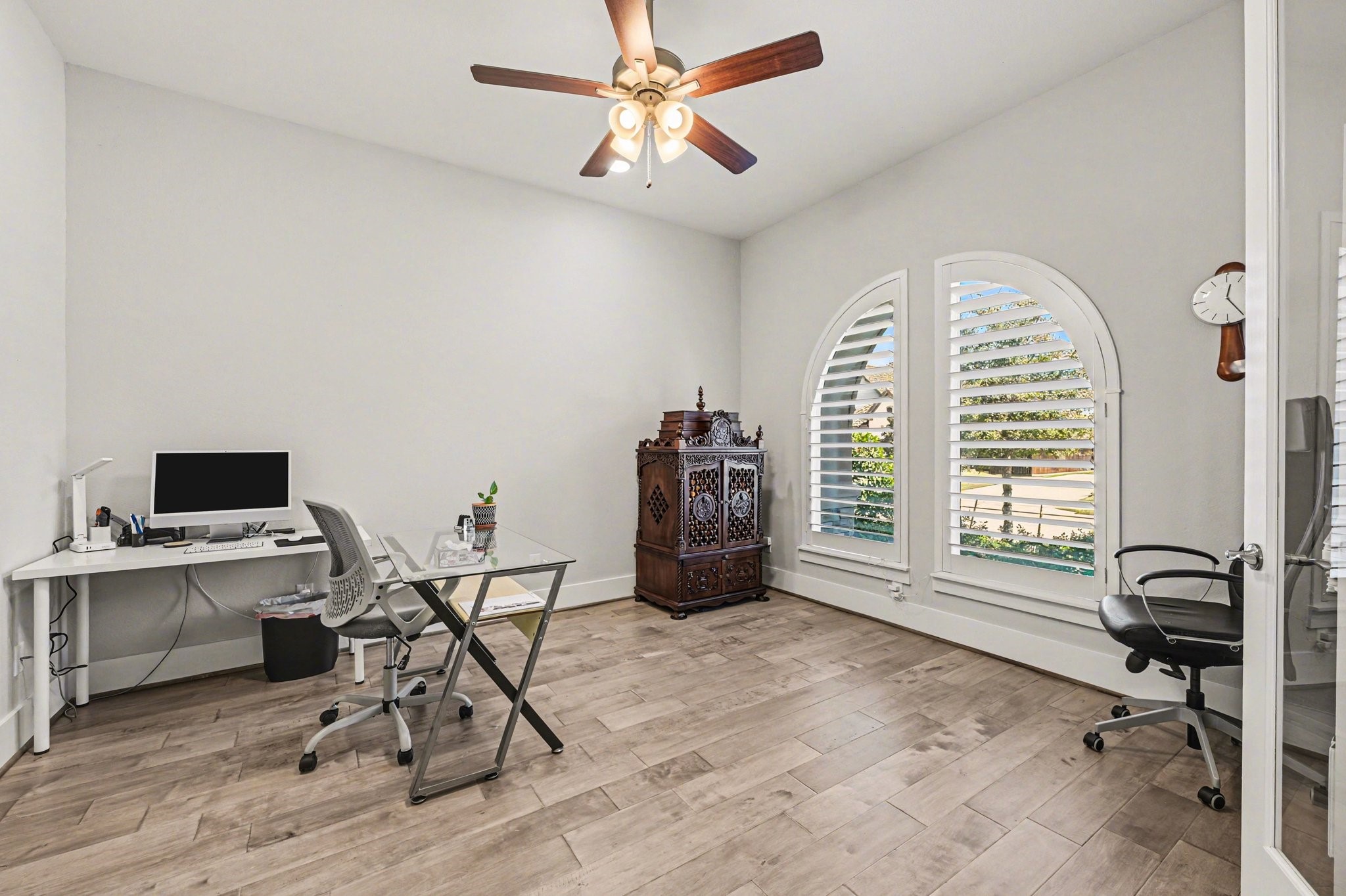 2311 Legends Way Katy, TX 77493 - Photo 27 of 50 Dedicated home office with beautiful arched windows and plantation shutters offers a quiet, light-filled workspace. An ideal setting for remote work or creative pursuits.