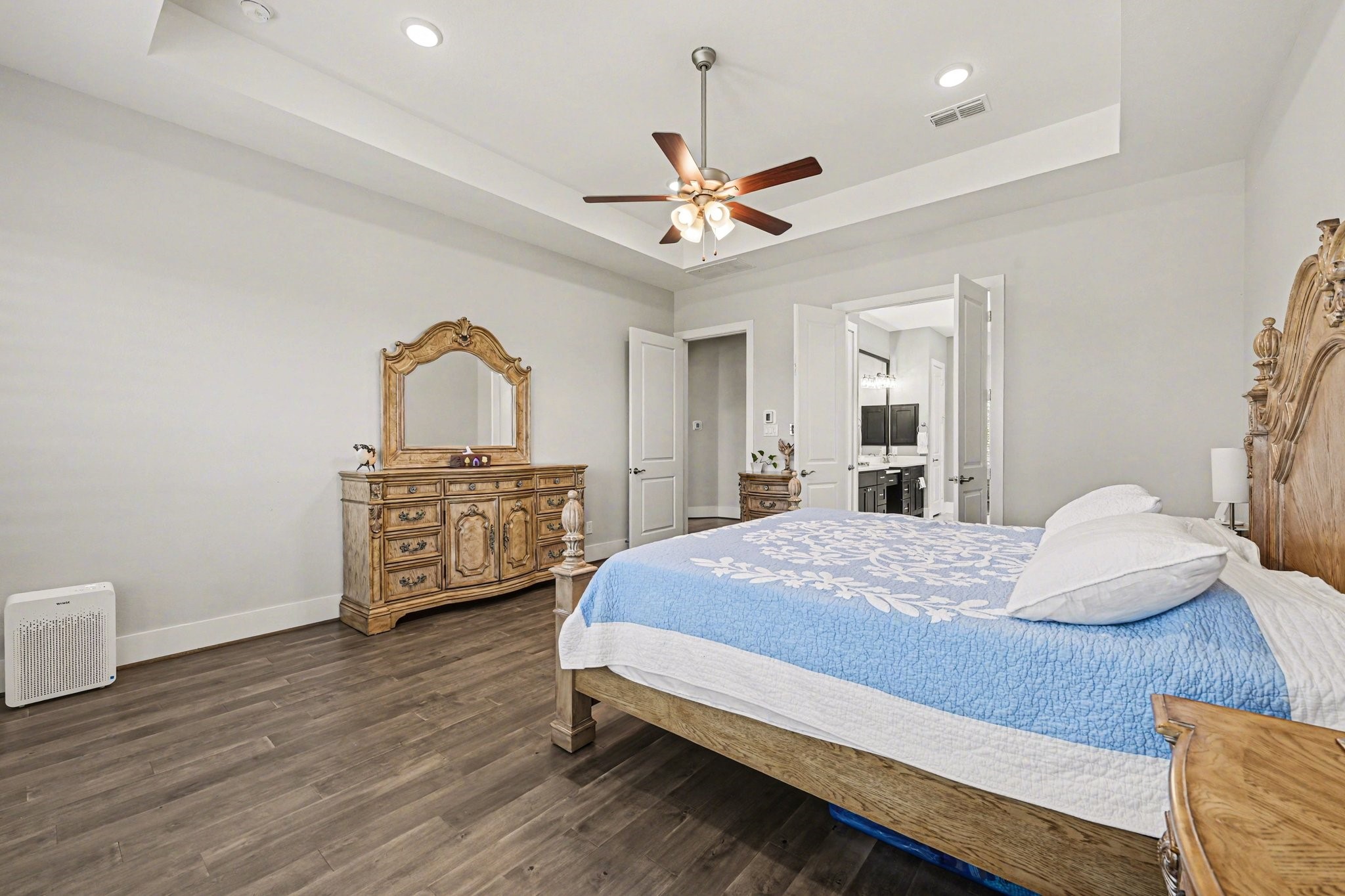 2311 Legends Way Katy, TX 77493 - Photo 29 of 50 Spacious owner’s retreat with tray ceiling detail and direct access to the spa-inspired bath. The layout provides privacy, comfort, and refined elegance throughout.