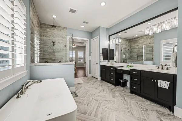 a large bathroom with a large mirror vanity and a sink