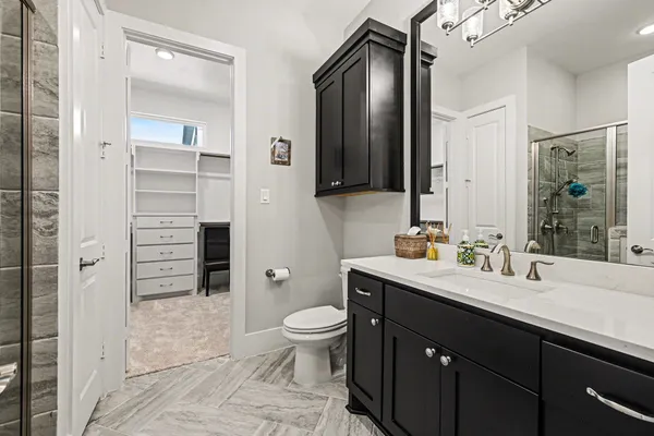 a bathroom with a double vanity sink a mirror and a shower