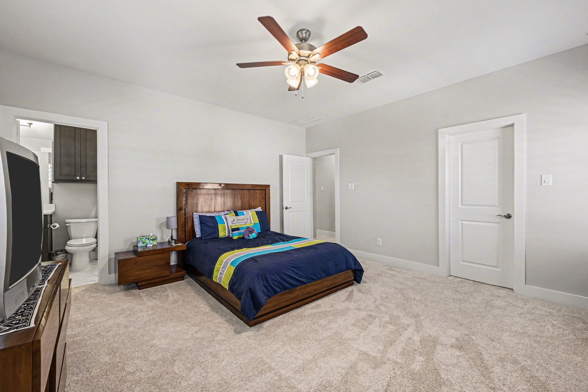 2311 Legends Way Katy, TX 77493 - Photo 36 of 50 Generously sized secondary bedroom with plush carpeting, neutral tones, and ceiling fan for comfort. Ample wall space allows for flexible furniture placement and personalization.