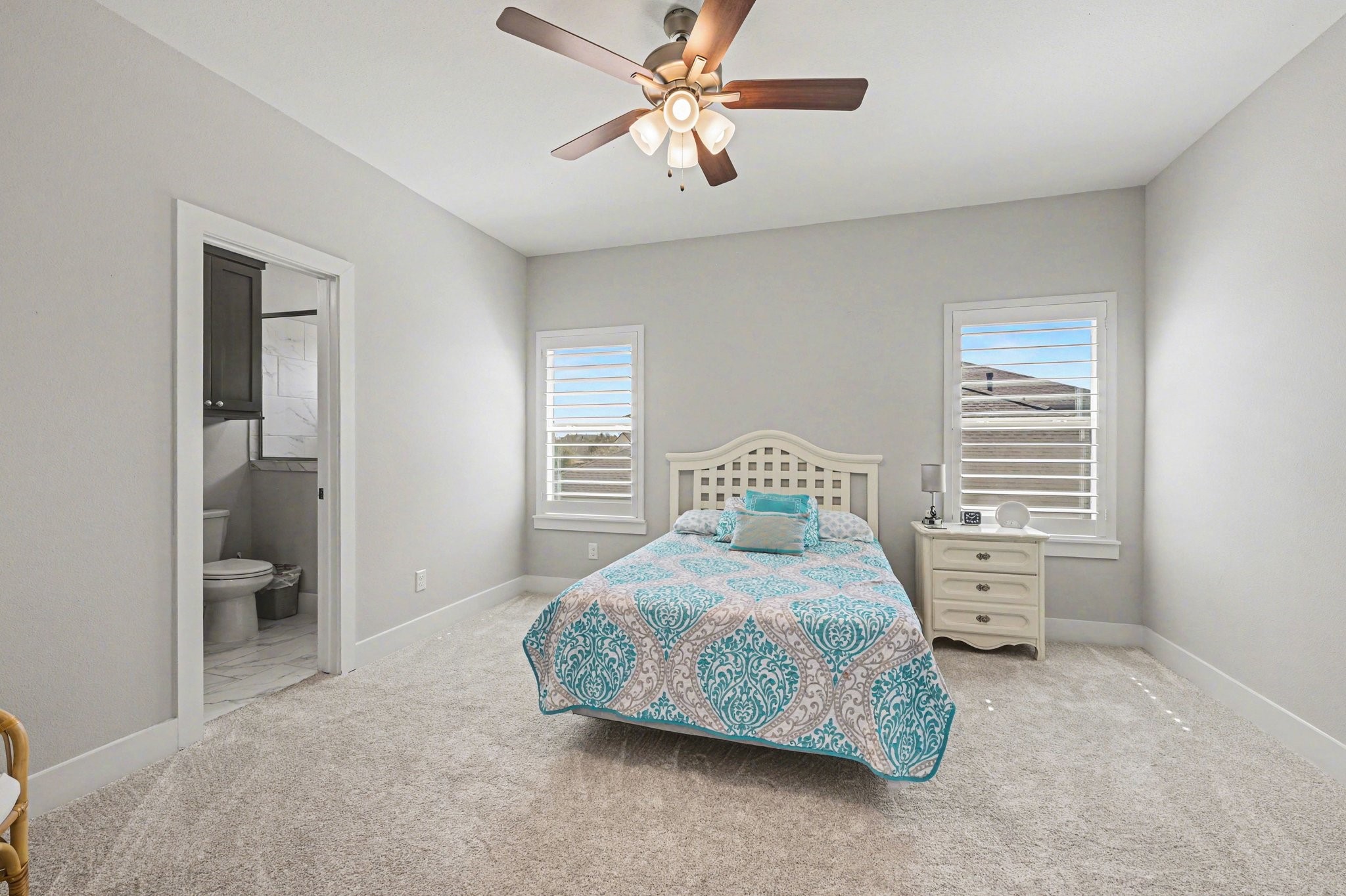 2311 Legends Way Katy, TX 77493 - Photo 38 of 50 Spacious bedroom filled with natural light and direct access to a private bath—ideal for guests or multigenerational living.