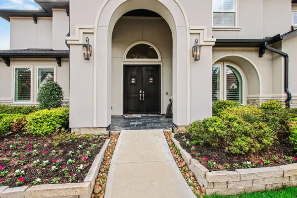 a front view of a house with a garden