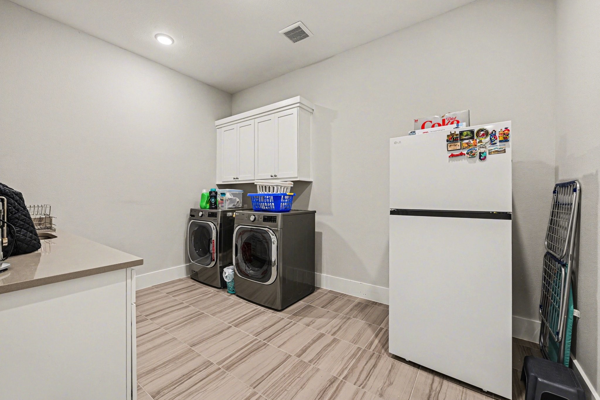 2311 Legends Way Katy, TX 77493 - Photo 41 of 50 Spacious utility room with upper cabinetry for storage and ample counter space for folding and organization. Functional layout makes daily tasks effortless.