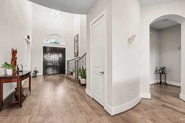 a view of hallway with livingroom and wooden floor