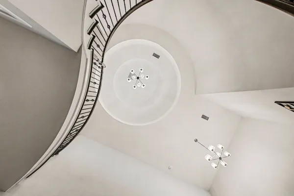 a living room with furniture a fireplace and a floor to ceiling window