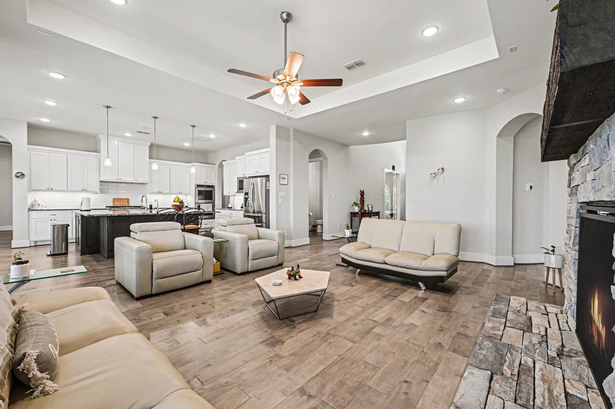 2311 Legends Way Katy, TX 77493 - Photo 10 of 50 Designed for both comfort and entertaining, this open living area offers generous seating space, elevated tray ceilings, and effortless connection to the kitchen and dining areas.