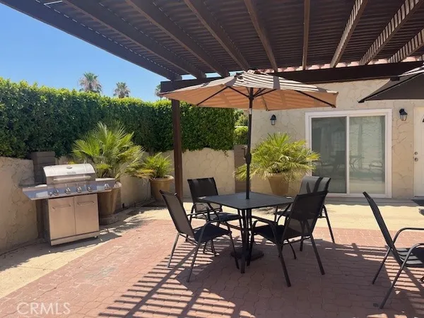 a patio with a table and chairs