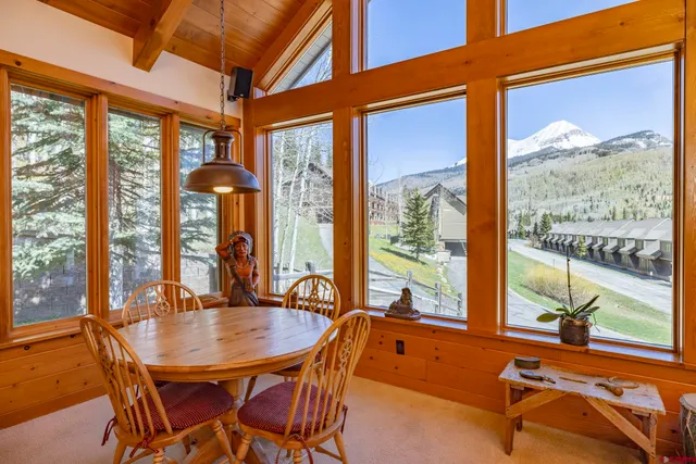 a view of a dining room with furniture large windows and wooden floor