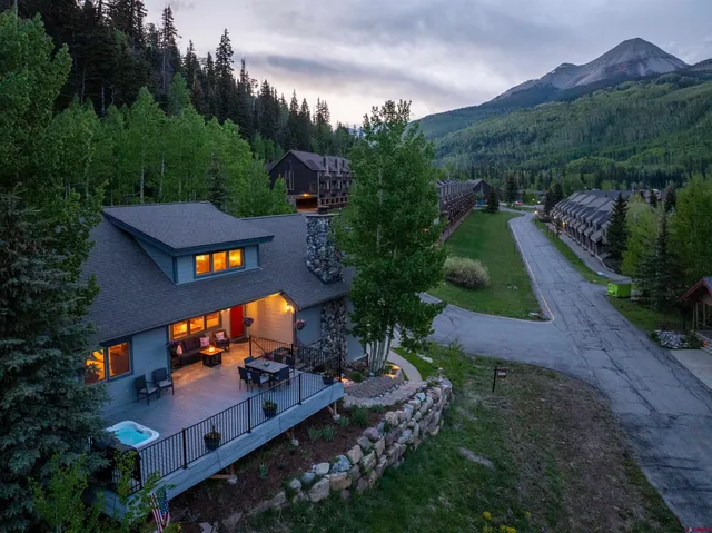 a living room with furniture a fireplace and a table