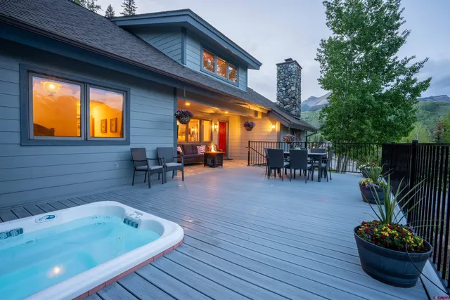 a living room with furniture a fireplace and a chandelier