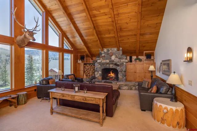 a dining room with furniture and a large window