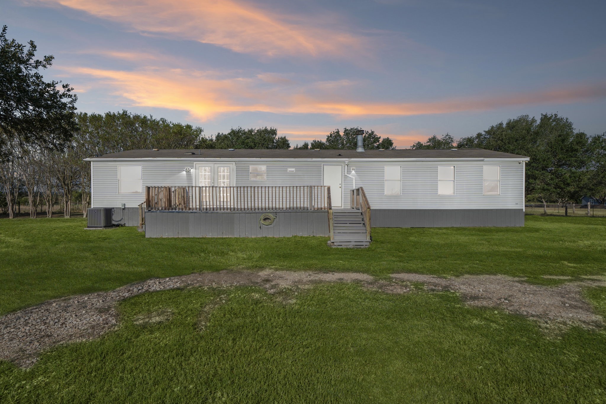 a view of a house with a backyard and a garden