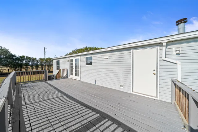 a view of a balcony with wooden floor