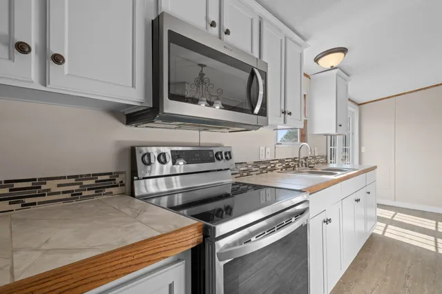 a kitchen with a stove and a microwave