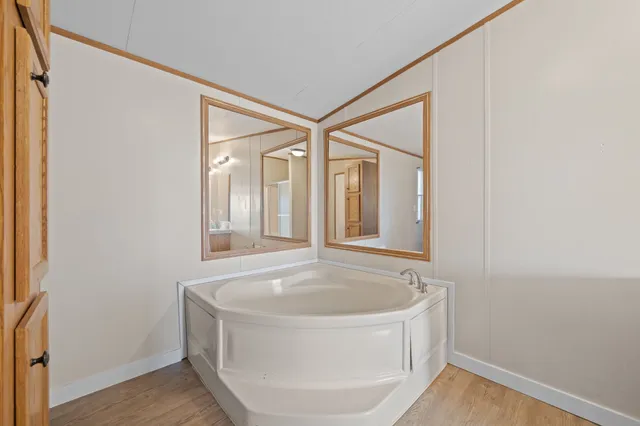 a bathroom with bathtub and window