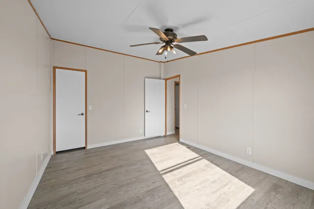 a view of a big room with wooden floor and closet in a kitchen