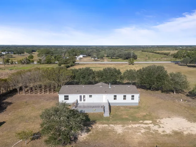 an aerial view of a house with a yard