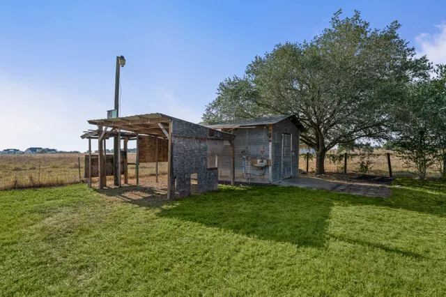 a view of a house with a yard and sitting area