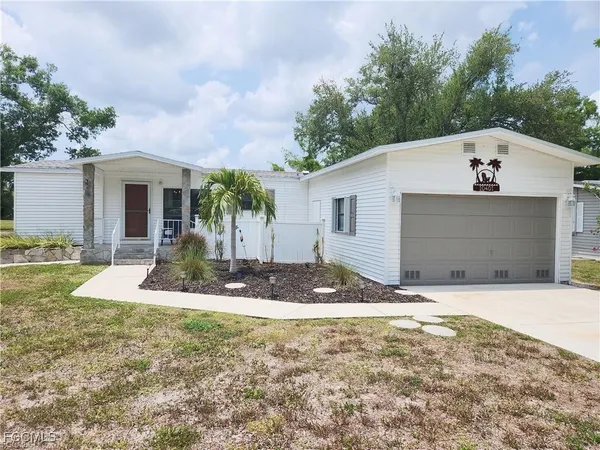 a view of a yard in front view of a house