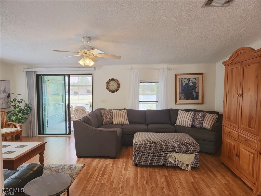10401 Circle Pine Road North Fort Myers, FL 33903 - Photo 7 of 20 a living room with furniture and a large window