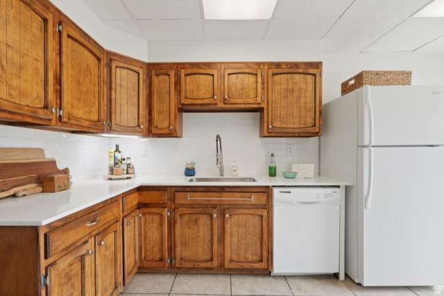 673 East 700 South Springville, UT 84663 - Photo 12 of 43 Kitchen featuring wood cabinetry, white countertops, white subway tile backsplash, stainless steel sink with pull-down faucet, and white appliances