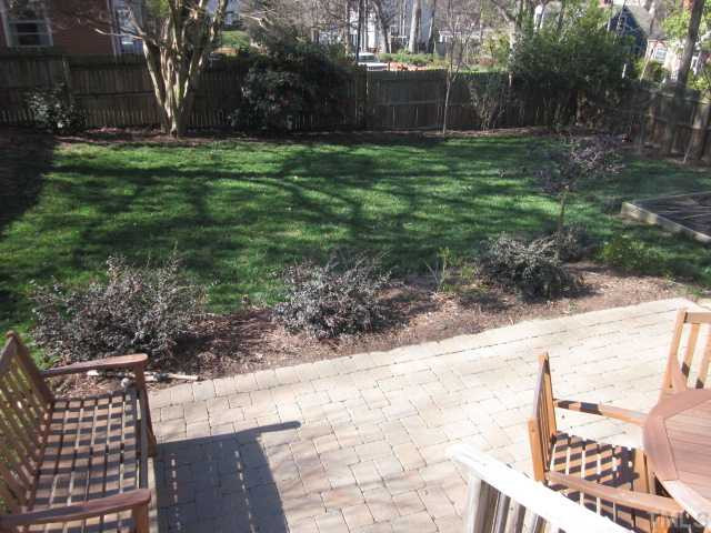 Here is a lovely view of the fenced in back yard! Plenty of room for the kids and/or pets to run and play in this area! Cobble stone patio with rear covered entry into clean basement area! Patio/Deck
