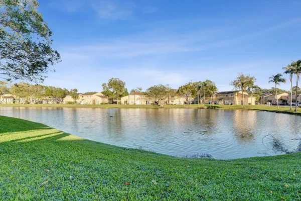a view of a lake with houses in the back