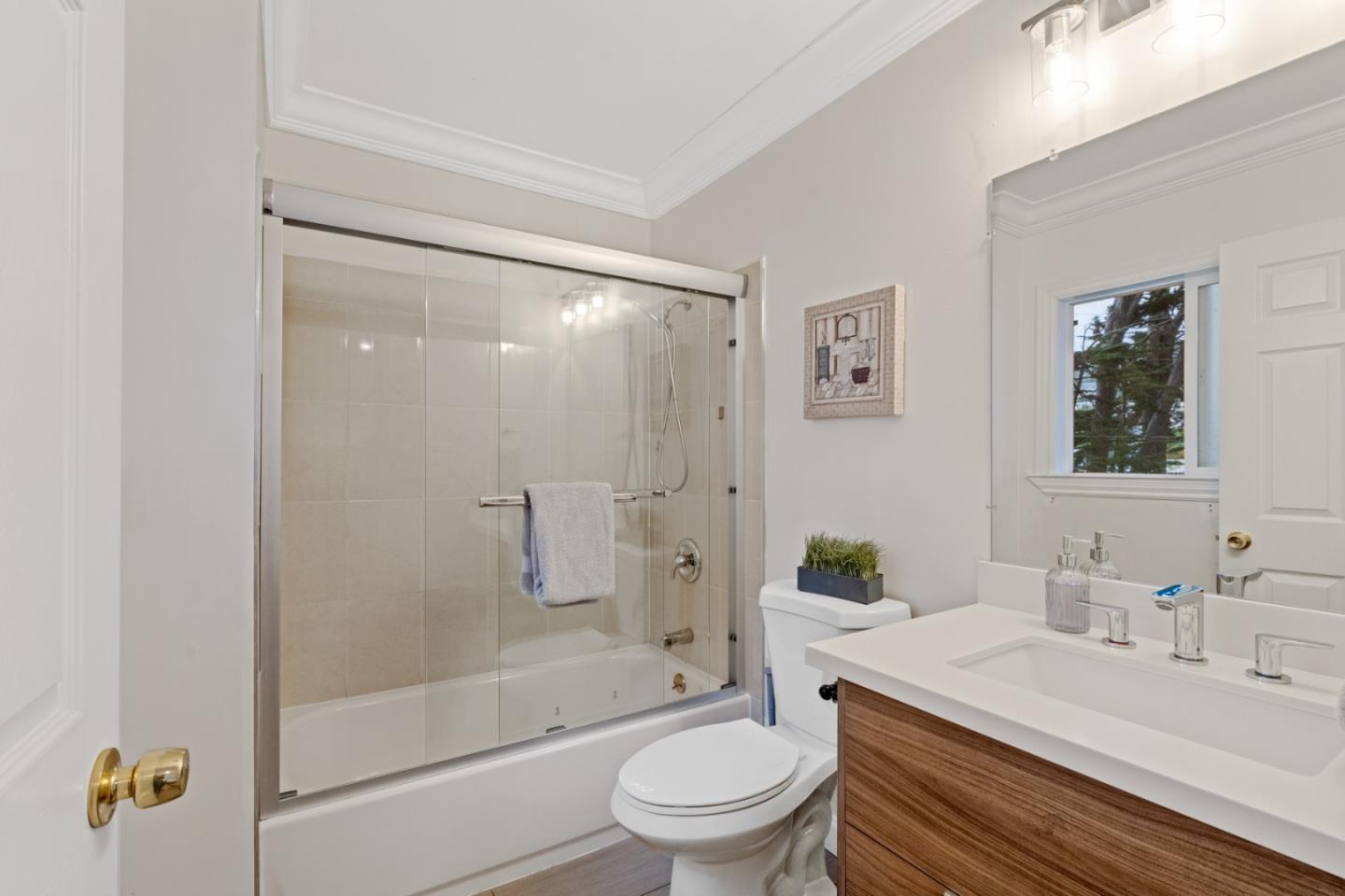 301 Channing Way Pacifica, CA 94044 - Photo 21 of 68 a bathroom with a sink a toilet and a large mirror