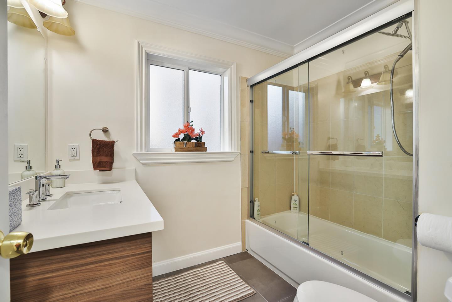 301 Channing Way Pacifica, CA 94044 - Photo 22 of 68 a bathroom with a bathtub shower sink vanity and toilet