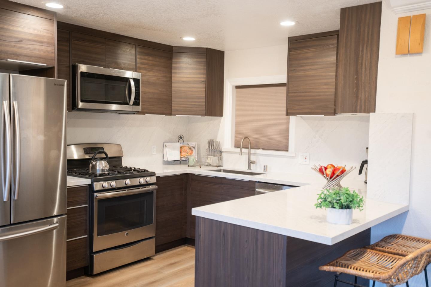 301 Channing Way Pacifica, CA 94044 - Photo 9 of 68 a kitchen with stainless steel appliances a stove a sink and a refrigerator